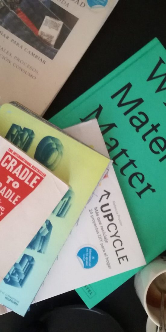 books on circular economy on a desk, among them cradle to cradle, why materials matter, sustainable fashion